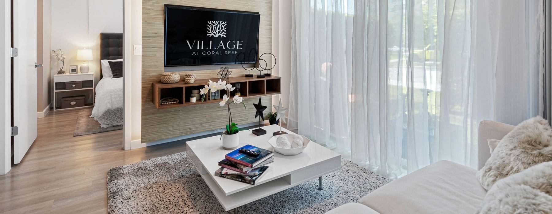 living room with coffee table and wall mounted tv