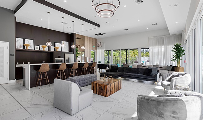 room with a kitchen couch chairs and coffee table